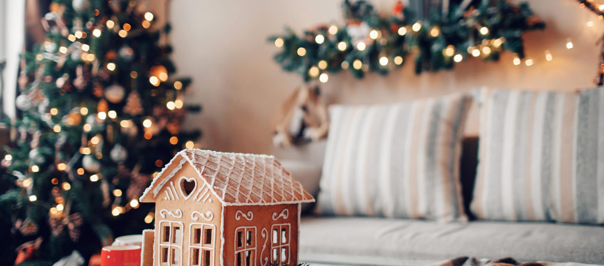 Homemade gingerbread house on light room background